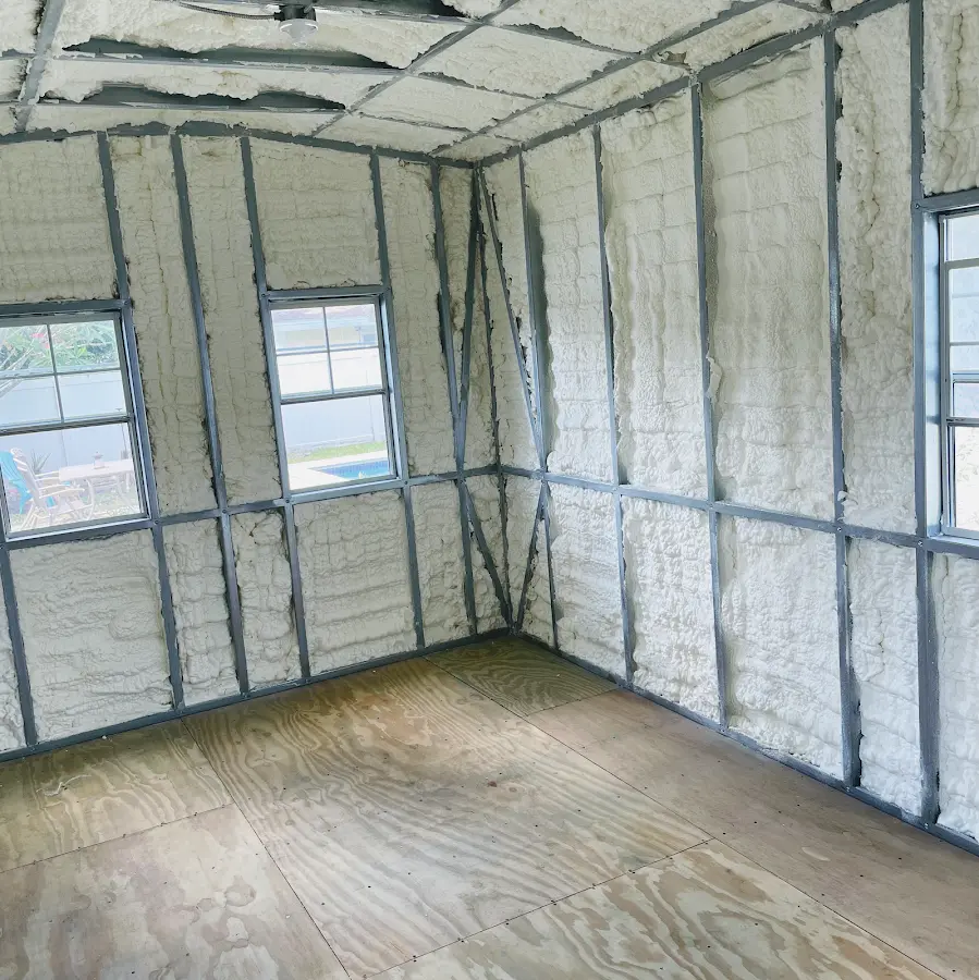 Closed-cell spray foam insulation applied to wall cavities in a residential project in Malverne